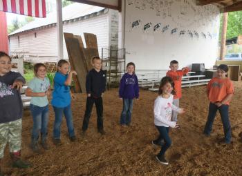 Children are playing an icebreaker game in a barn in Scio, Oregon.