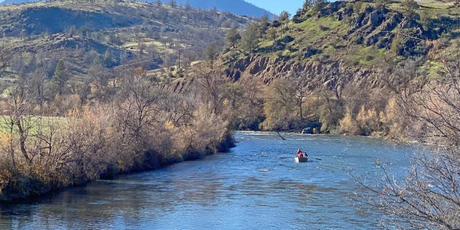 People are fishing in a boat on the Klamath River.
