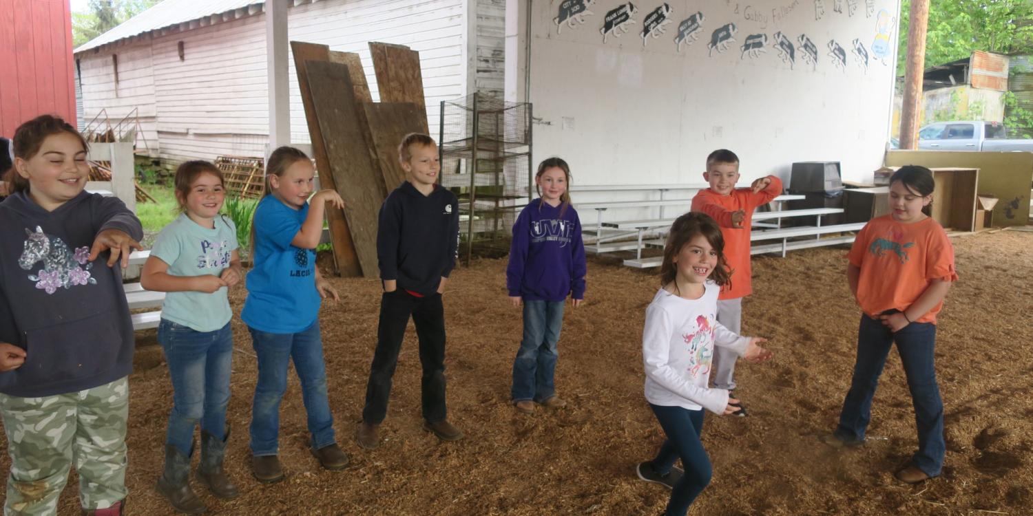 Children are playing an icebreaker game in a barn in Scio, Oregon.