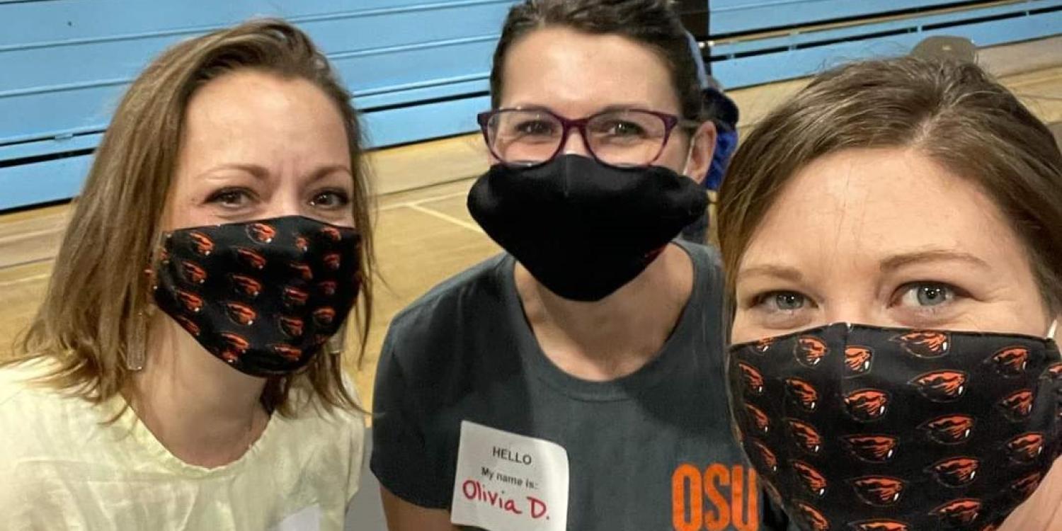 Three women Extension employees are posing for a photo wearing facemasks.