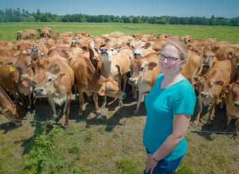 Jenifer Cruickshank with a herd of jersey heifers at Forest Glen Oaks Dairy in Yamhill County.