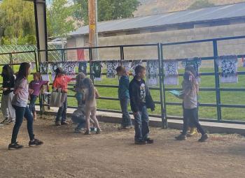 Children doing an activity in a barn at the Klamath 4-H Cloverbud Camp.