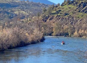 People are fishing in a boat on the Klamath River.