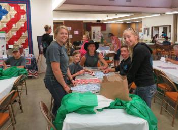 4-H members in Josephine County sewingg and filling stockings for the military.